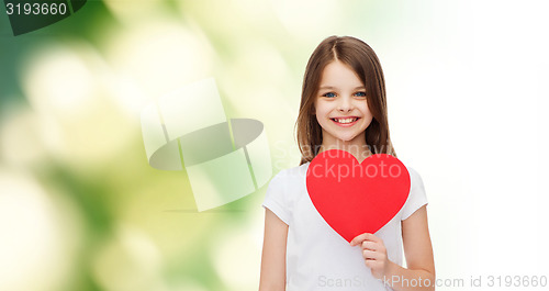 Image of beautiful little girl sitting at table