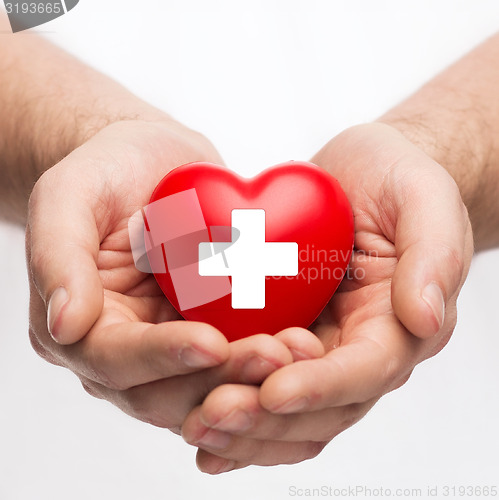 Image of male hands with red heart