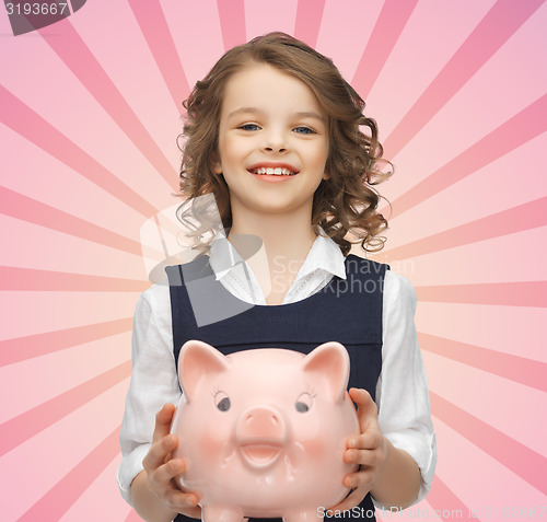 Image of happy girl holding piggy bank