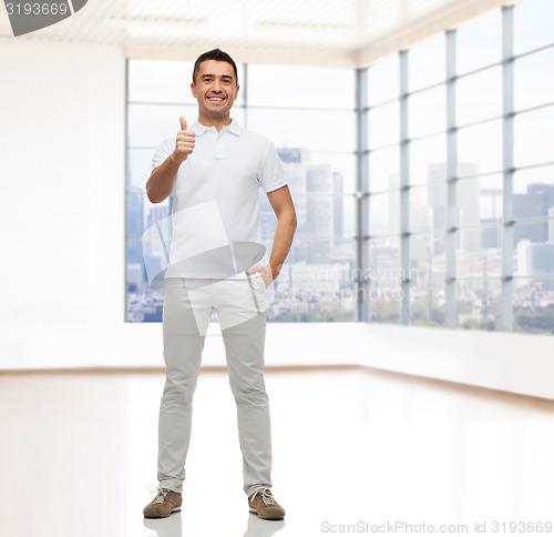 Image of smiling man showing thumbs up