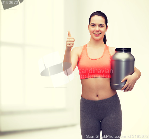 Image of teenage girl with jar of protein showing thumbs up