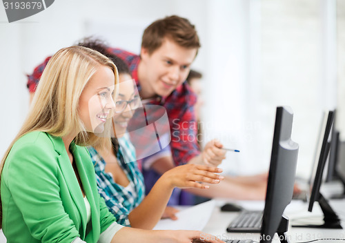 Image of students with computer studying at school