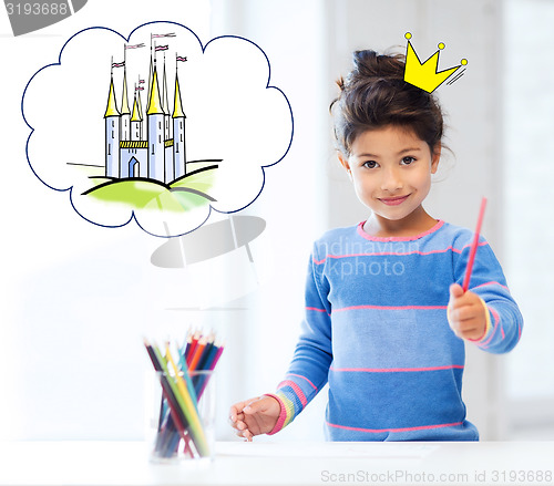 Image of happy little girl showing pencil or crayon