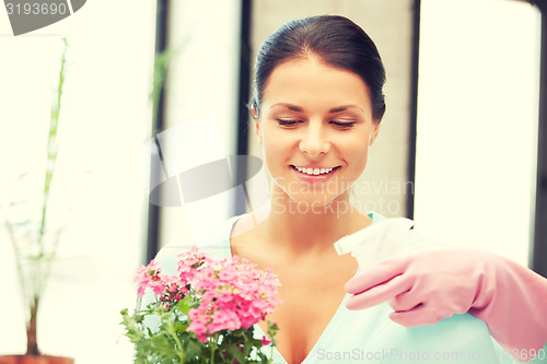 Image of lovely housewife with flower