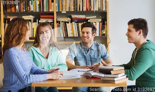 Image of students with books preparing to exam in library