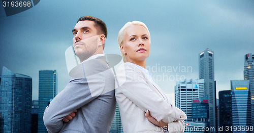 Image of businessman and businesswoman outdoors