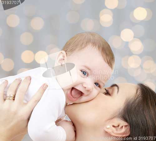 Image of happy mother with baby over lights background