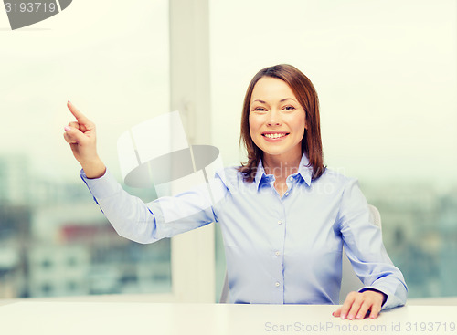 Image of smiling woman pointing to something imaginary