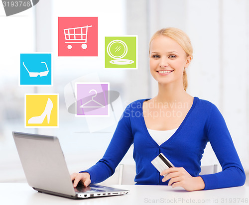 Image of happy businesswoman with laptop and credit card
