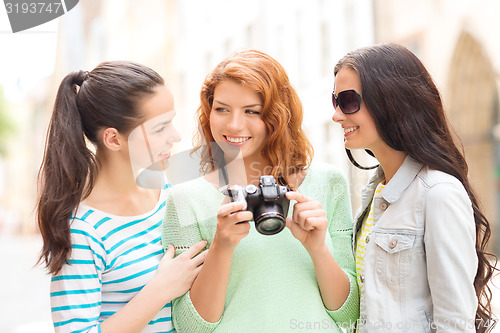 Image of smiling teenage girls with camera