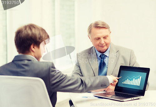 Image of older man and young man with laptop computer