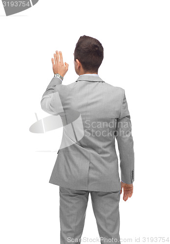 Image of businessman touching something imaginary