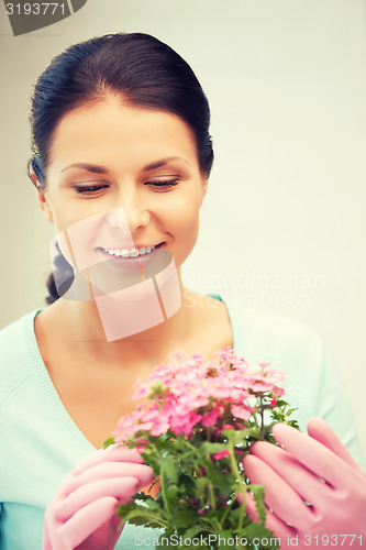 Image of lovely housewife with flower