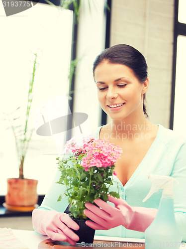 Image of lovely housewife with flower