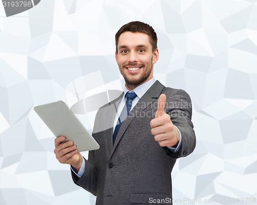 Image of smiling businessman with tablet pc computer