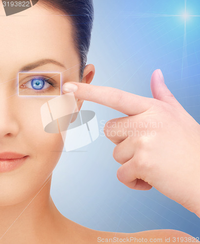 Image of beautiful woman pointing to eye