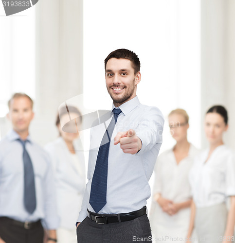 Image of handsome businessman pointing finger at you