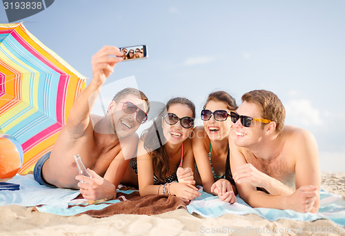 Image of group of friends taking selfie with cell phone