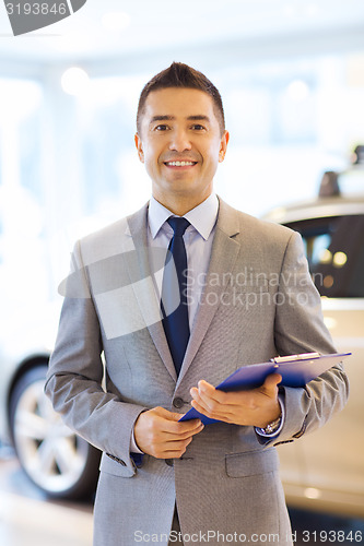 Image of happy man at auto show or car salon