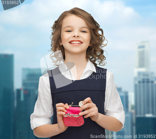 Image of happy girl with purse and euro coin money