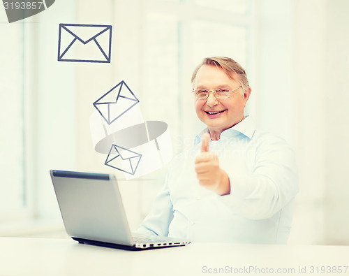 Image of old man with laptop computer showing thumbs up