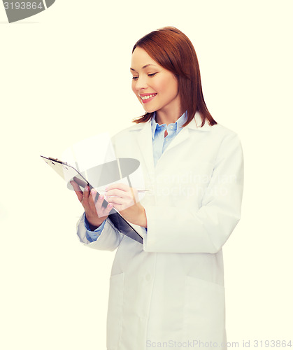 Image of smiling female doctor with clipboard