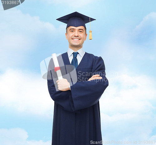 Image of smiling adult student in mortarboard with diploma