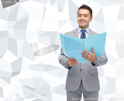 Image of happy businessman with open folder
