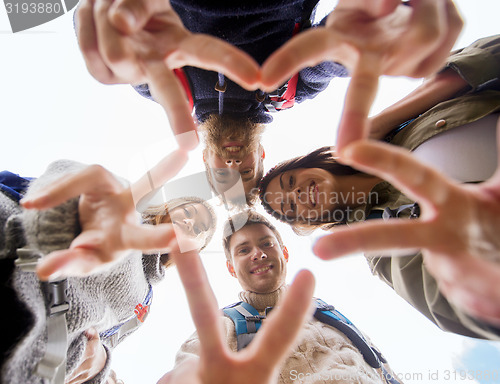 Image of group of smiling friends with backpacks hiking