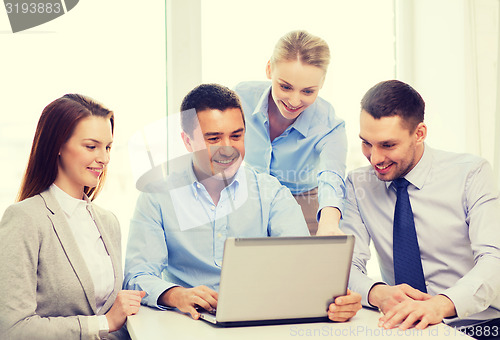 Image of business team working with laptop in office