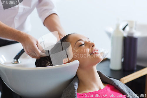 Image of happy young woman at hair salon