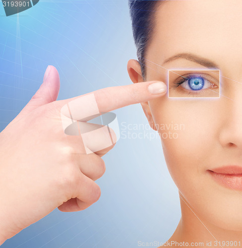 Image of beautiful woman pointing to eye
