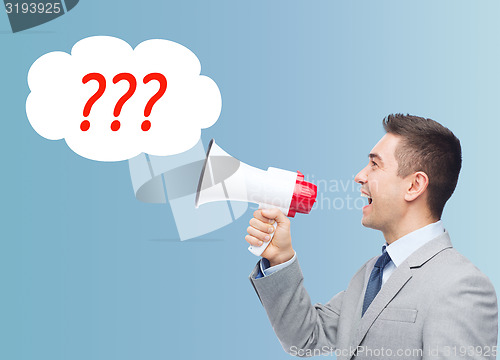 Image of happy businessman in suit speaking to megaphone