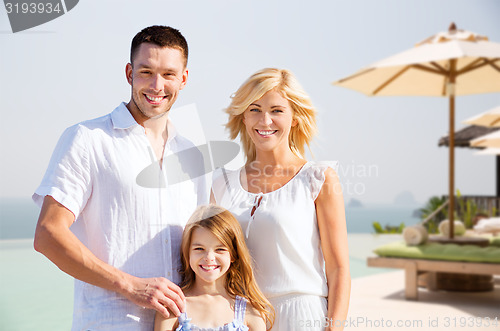 Image of happy family on summer vacation at resort beach