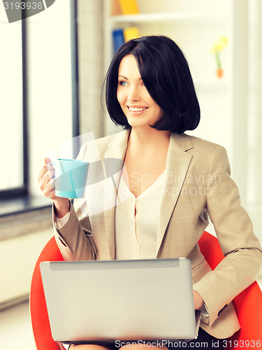 Image of happy woman with laptop computer