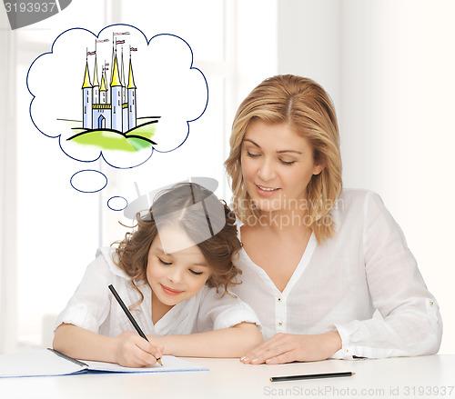 Image of happy mother and daughter drawing at home