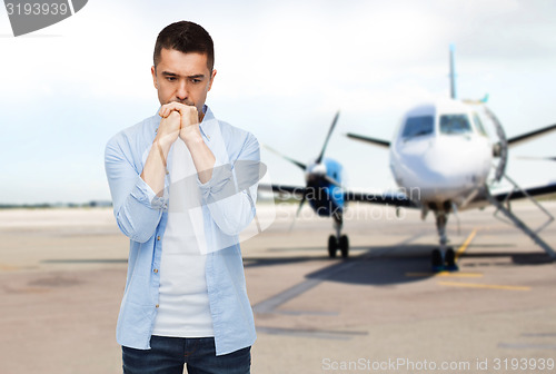 Image of man thinking over airplane on runway background