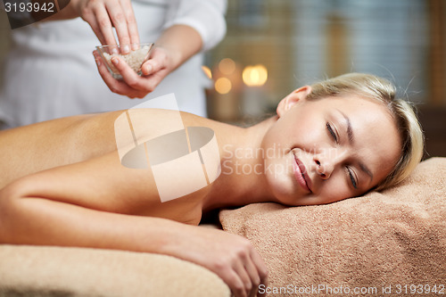 Image of close up of woman lying and having massage in spa