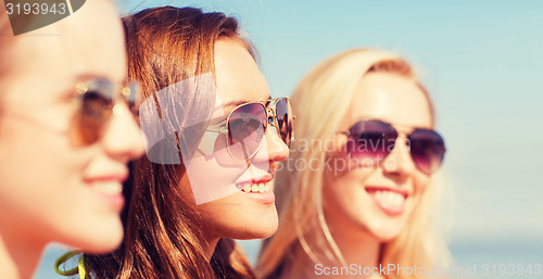 Image of close up of smiling young women in sunglasses