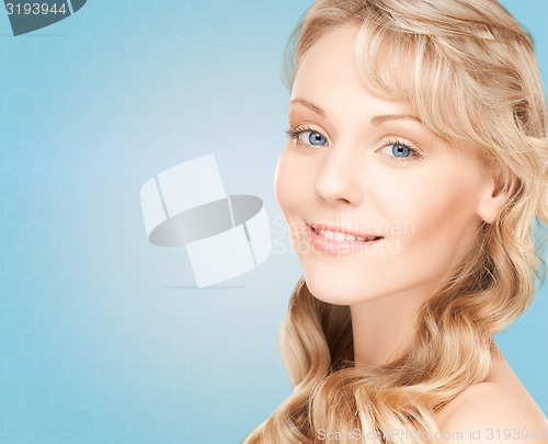 Image of beautiful young woman face with long wavy hair