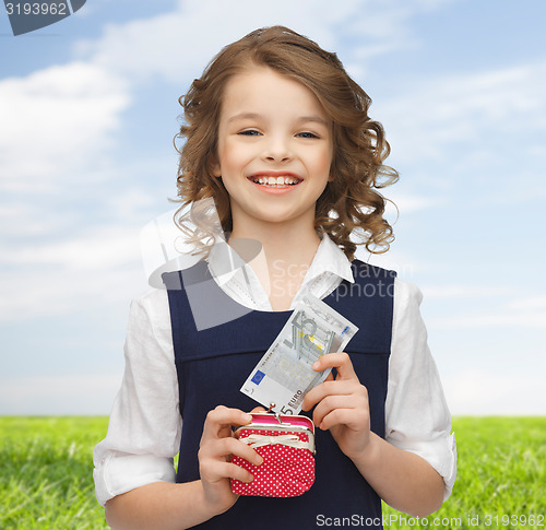 Image of happy girl with purse and paper money