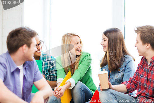 Image of students communicating and laughing at school