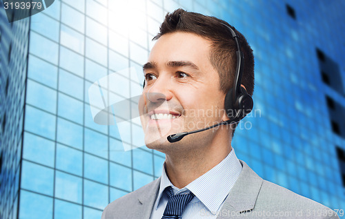 Image of smiling businessman in headset