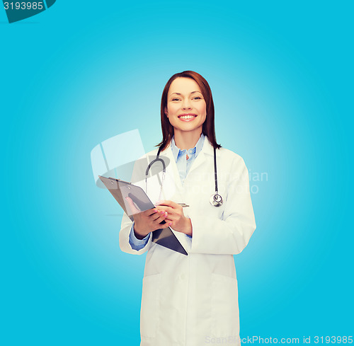 Image of smiling female doctor with clipboard