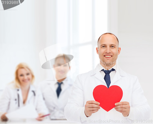 Image of smiling male doctor with red heart