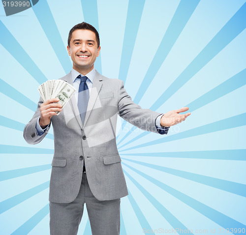 Image of smiling businessman with american dollar money