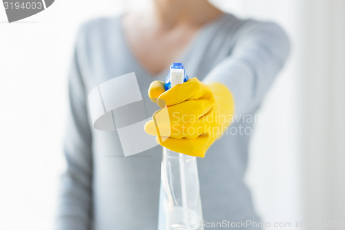 Image of close up of happy woman with cleanser spraying