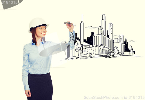 Image of businesswoman in helmet writing on virtual screen