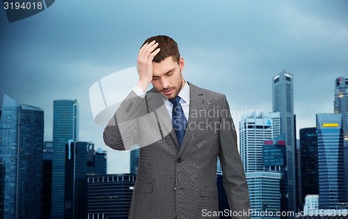 Image of young businessman having headache