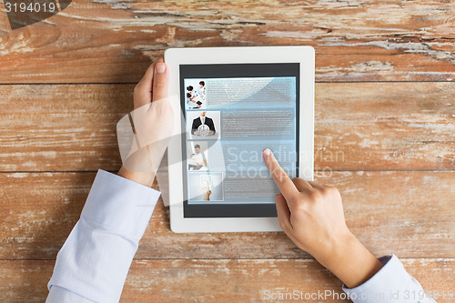 Image of close up of male hands showing blog on tablet pc